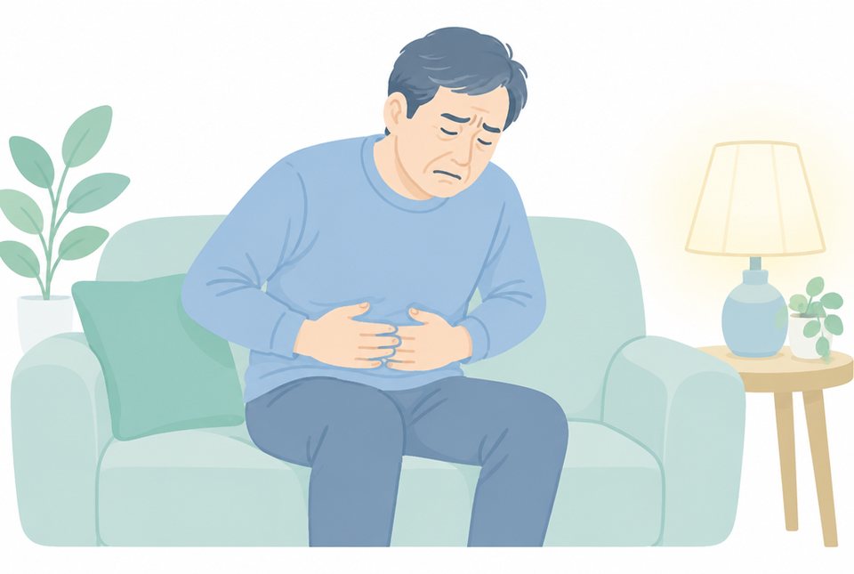 上腹部を押さえて前かがみに座る男性のイラスト